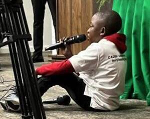 Gutt 15år med ryggmargsbrokk holder tale til forsamling i Zambia.